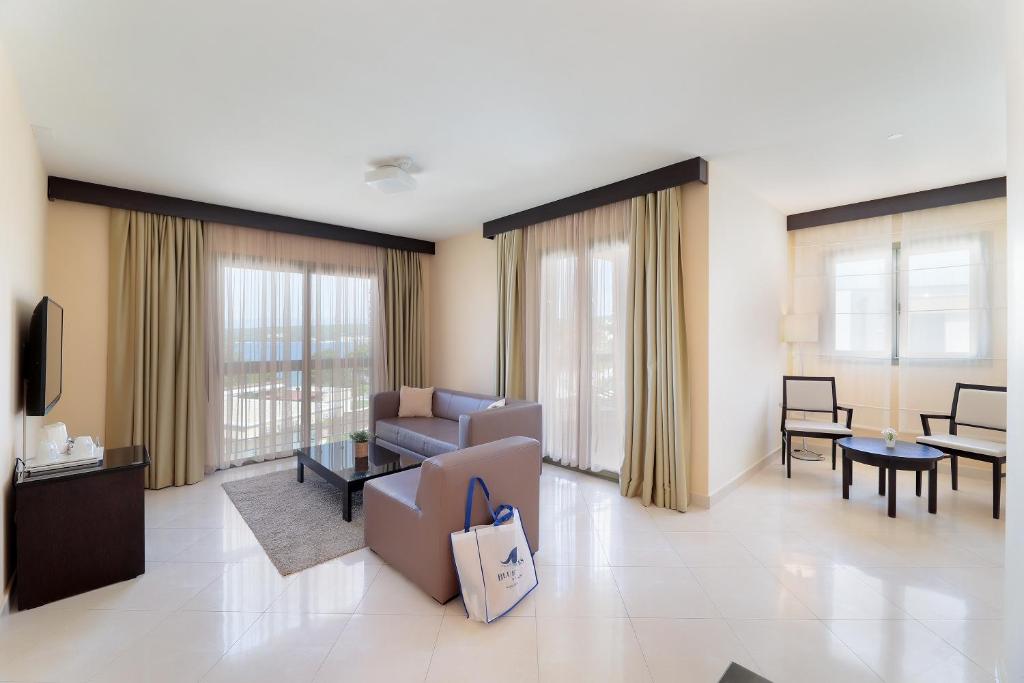 a living room with a couch and a table at Blue Waves Resort in Malinska