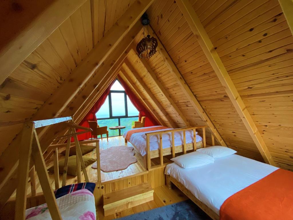 a room with two beds in a attic at Luxury Bungalow With Barbecue2 in Ardeşen