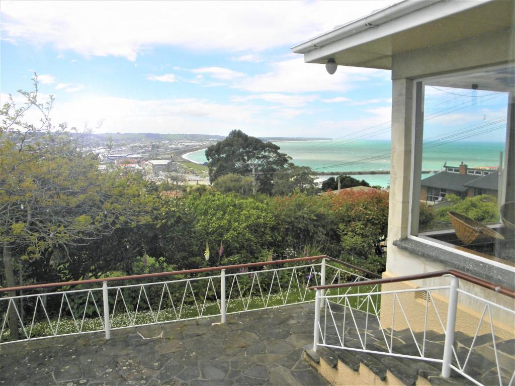 a balcony of a house with a view of the ocean at Seaview Villa in Oamaru