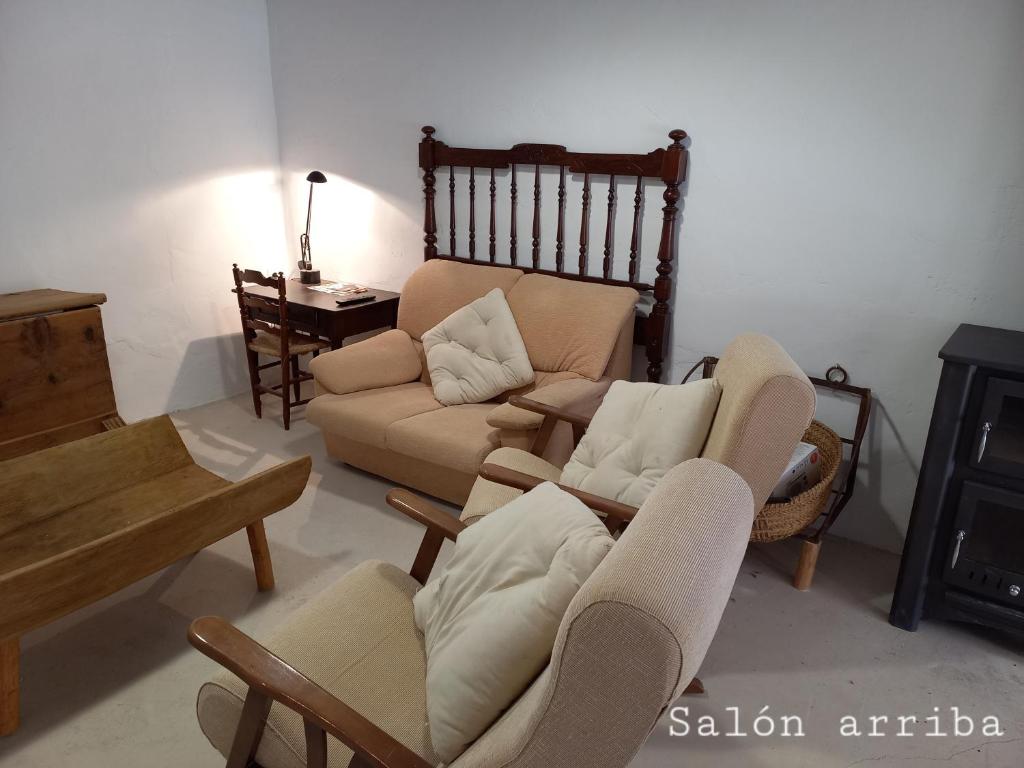 a living room with a couch and chairs and a table at Casa del Puente in Nerpio