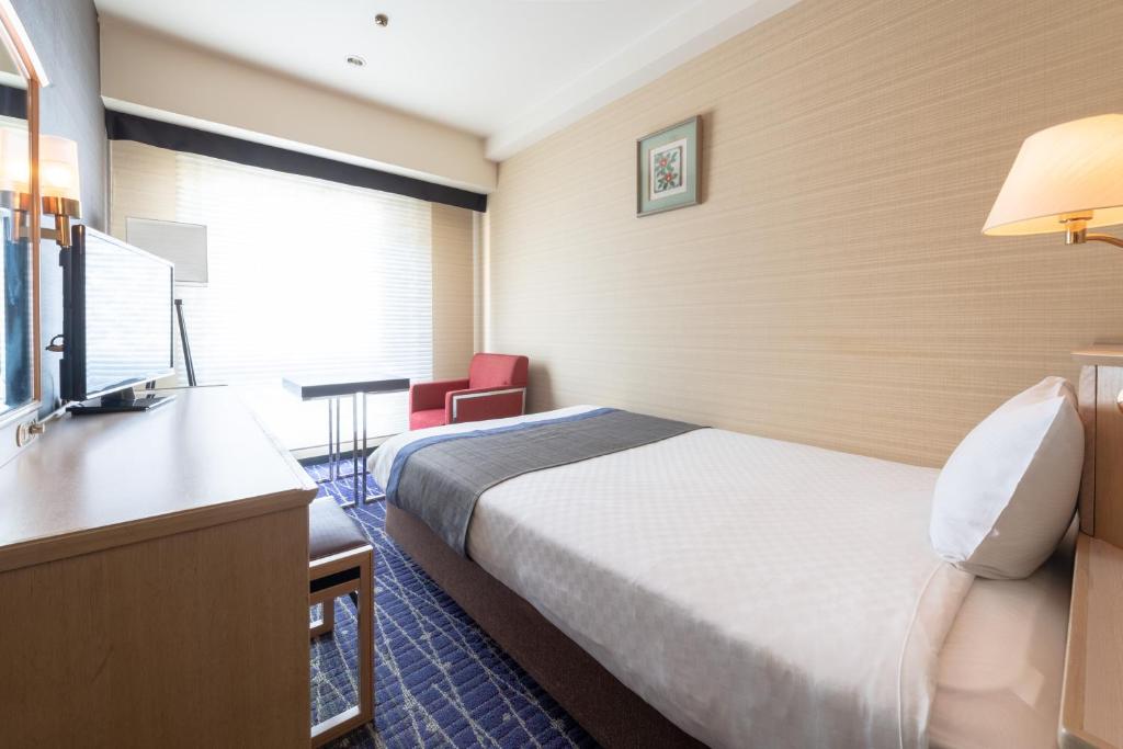 Postel nebo postele na pokoji v ubytování Hotel New Hankyu Kyoto