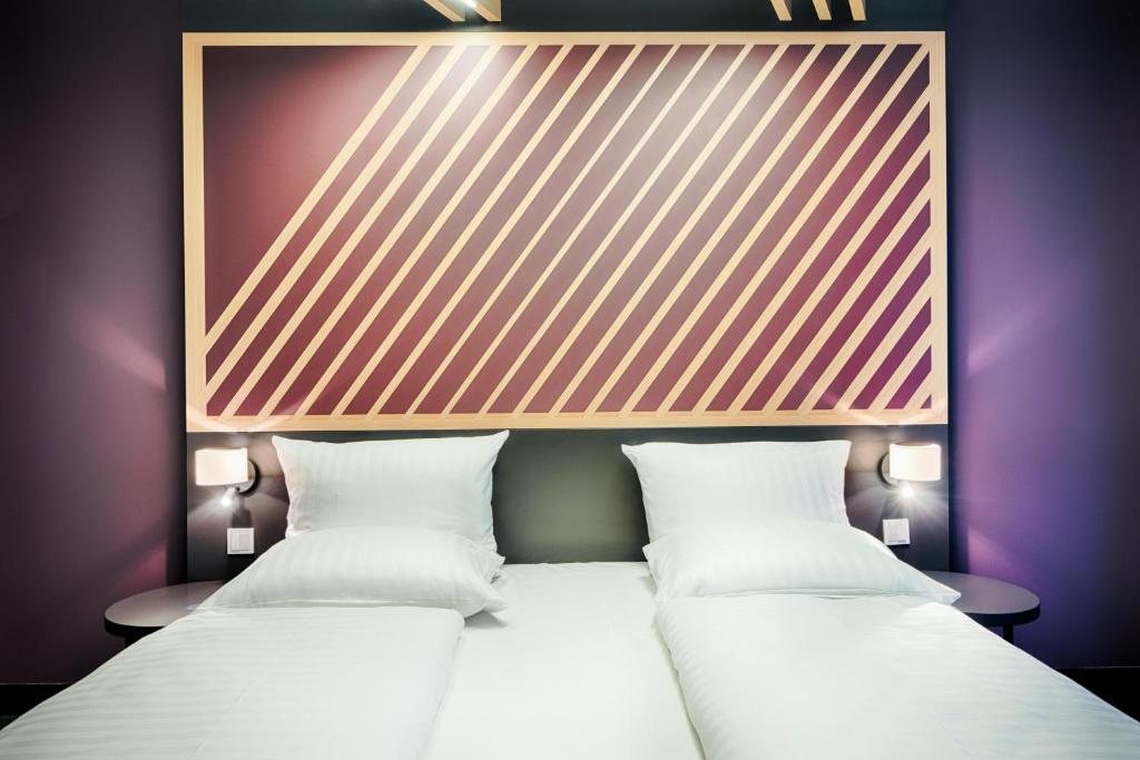Postel nebo postele na pokoji v ubytování B&B Hotel München-Hbf