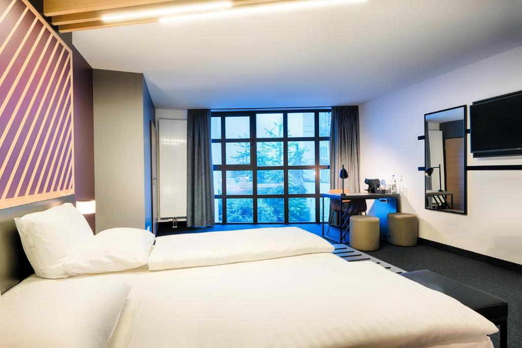Postel nebo postele na pokoji v ubytování B&B Hotel München-Hbf