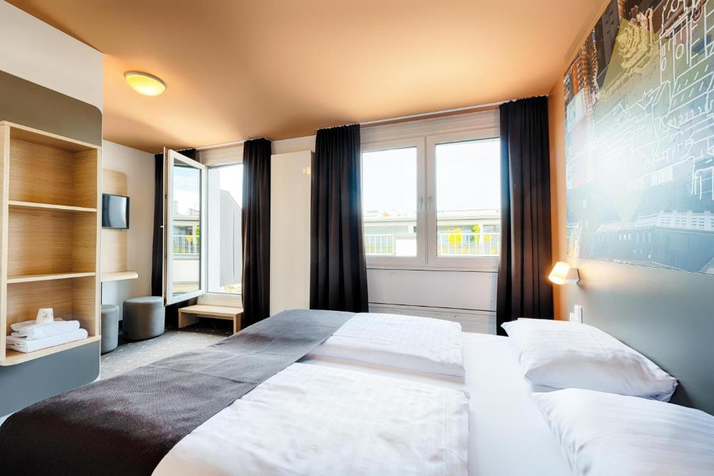 Postel nebo postele na pokoji v ubytování B&B Hotel München-Hbf