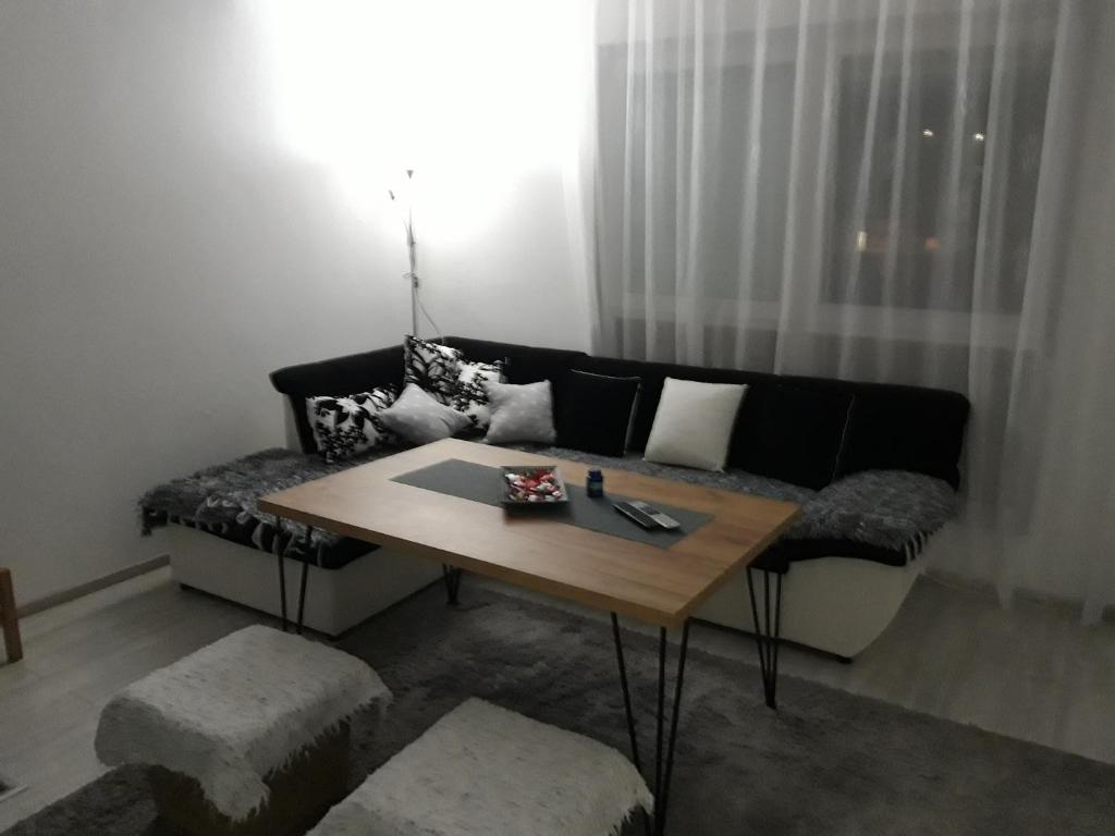 a living room with a couch and a table at Apartman Velez in Nevesinje