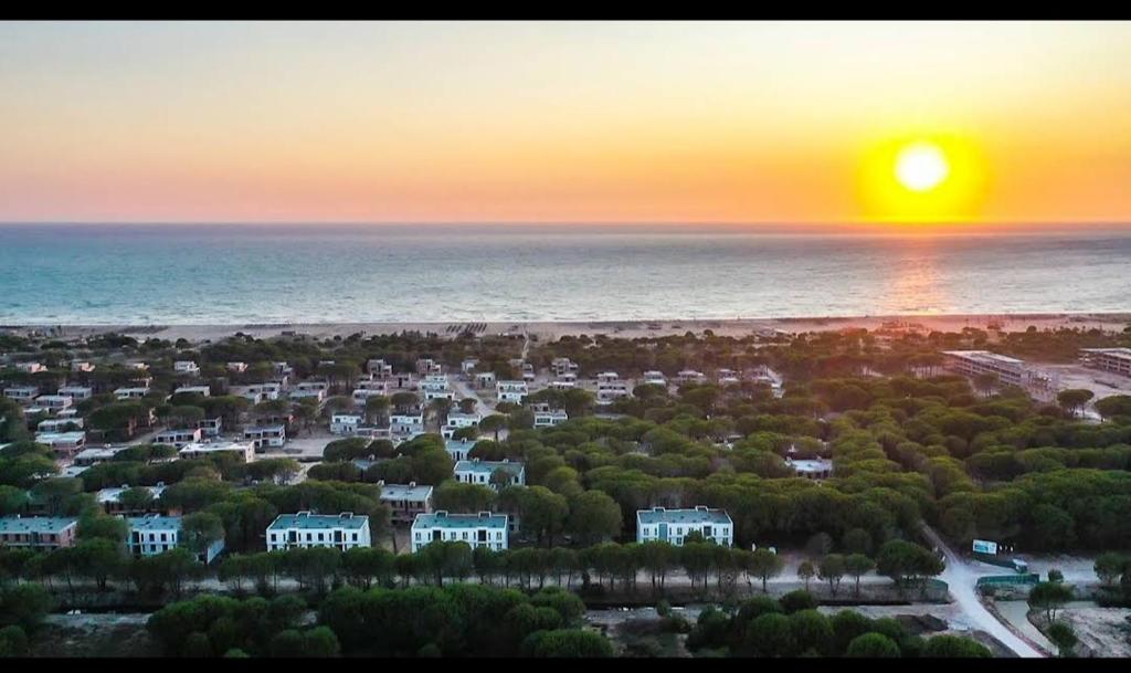 a sunset over the ocean with houses and trees at Illyrian Elite Gjiri i Lalezit in Durrës
