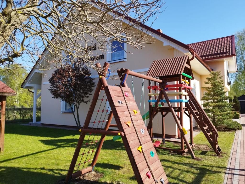 a playground in front of a house at Pod Platanem in Rowy