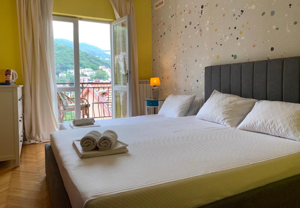 sypialnia z łóżkiem z dwoma ręcznikami w obiekcie Apartmani SRNA, Igalo w mieście Igalo