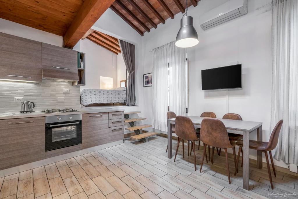 a kitchen with a table and chairs and a television at Florence Star Apartment in Florence