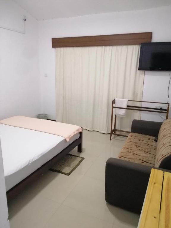 Postel nebo postele na pokoji v ubytování Glenview hotel & homestay