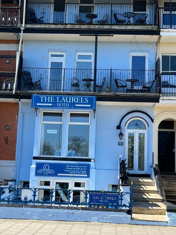 ein blaues Gebäude mit einem Schild für das Hotel Latkes in der Unterkunft The Laurels Hotel in Skegness