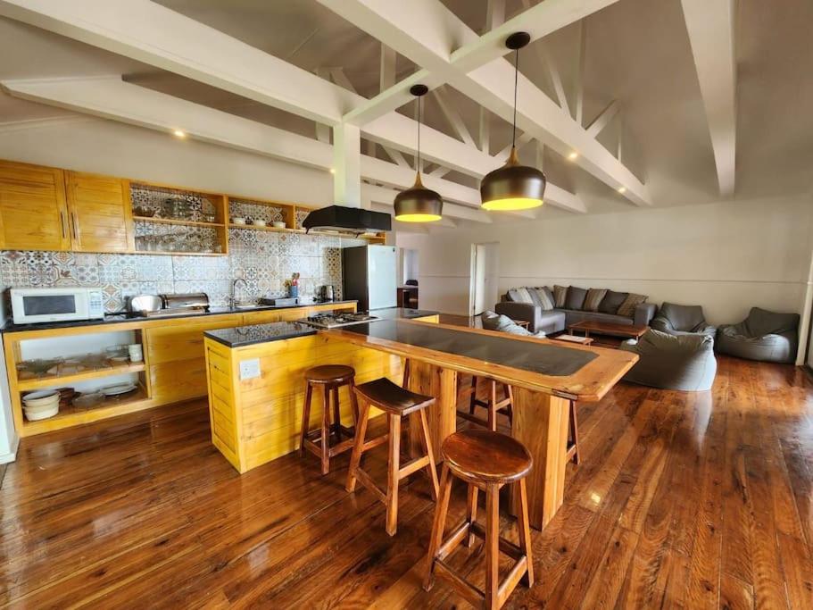 a kitchen with a large island with bar stools at Luxury Seaview Getaway in Lopes