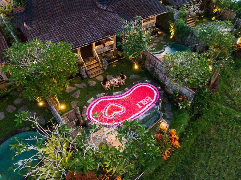 an overhead view of a backyard with a pool and a sign at Wooden Ganeca Villas by Pramana Villas in Ubud