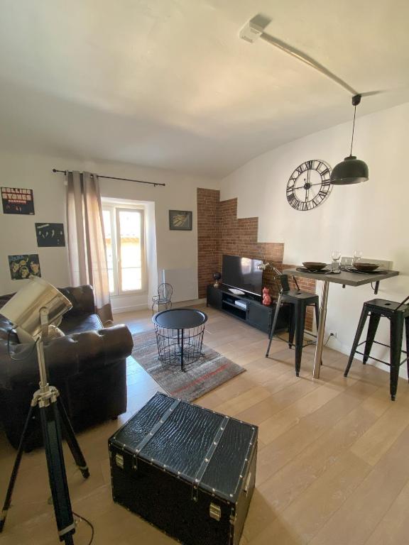 a living room with a couch and a table at Appartement Biot Village in Biot