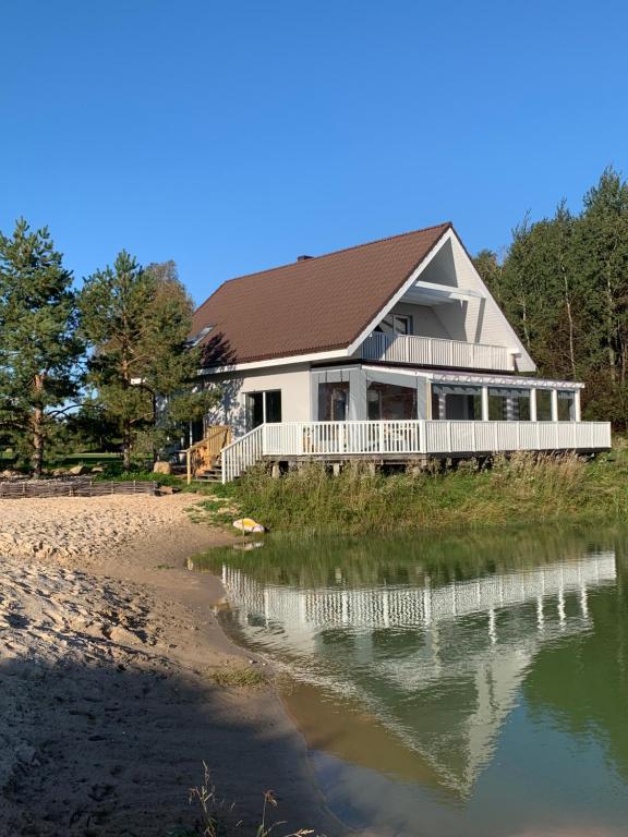 a house on the beach next to a body of water at DEJA VU in Kretinga