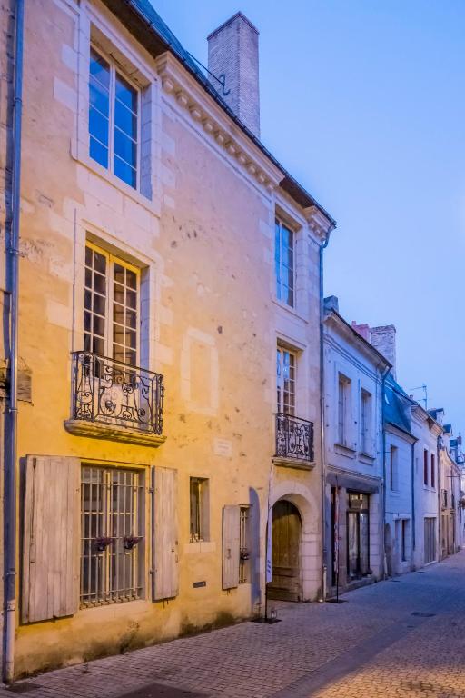 an old building on the side of a street at Logis Cointereau in Baugé-en-Anjou