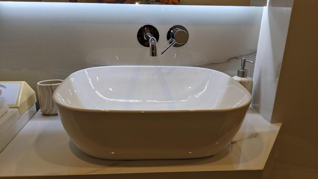 a bathroom sink with a large white bowl sink at Summer Life in Panayia