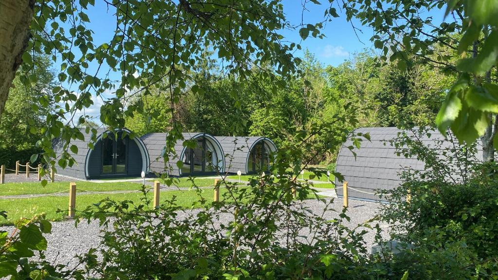 a building with two domes in a garden at Glamping at Share Discovery Village in Lisnaskea