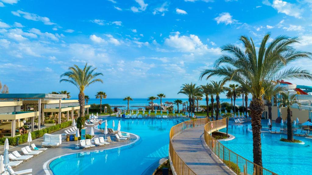 a view of a resort pool with palm trees at Liberty Hotels Lara in Lara