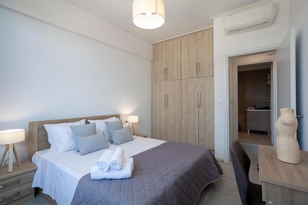 a bedroom with a bed with two towels on it at Attalos luxury flat Psyrri square in Athens