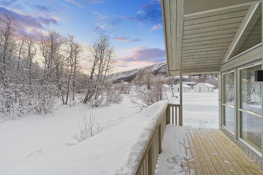 a porch of a house with snow on the ground at Tromsø Lodge & Camping in Tromsø