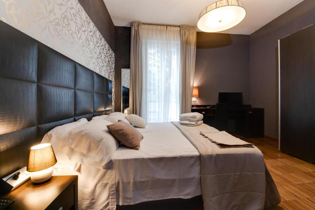 Postel nebo postele na pokoji v ubytování Atmosfere Milano Marittima