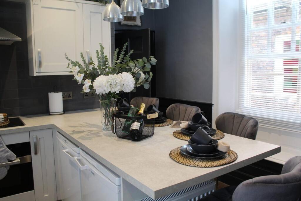 a kitchen with a table with hats on it at CARAMBOLA LUXURY AIR BNB IN THE HEART OF BEVERLEY in Beverley