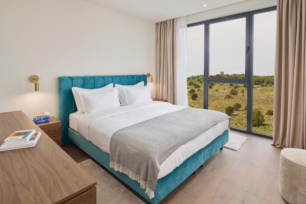 Postel nebo postele na pokoji v ubytování Petram Resort & Residences