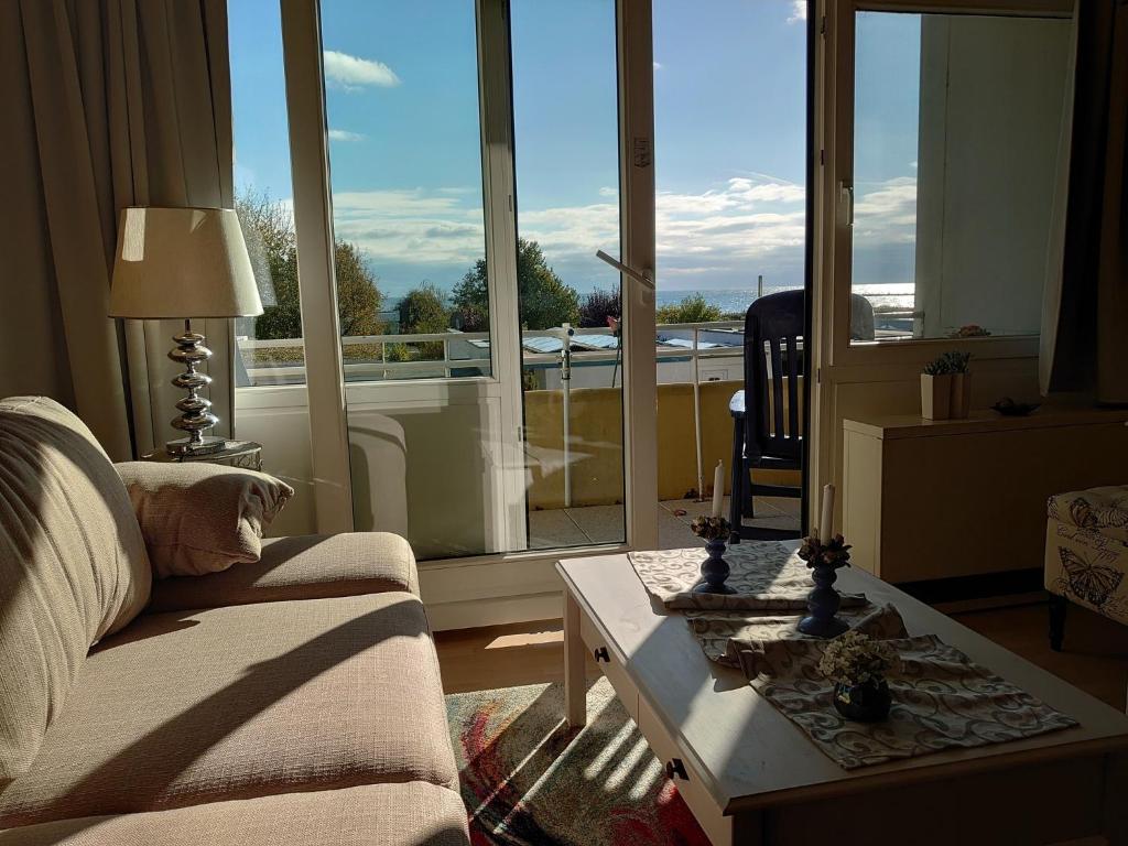 ein Wohnzimmer mit einem Sofa und einem Tisch in der Unterkunft "Mit Ausblick"-uneingeschränkter Meerblick in Burgtiefe auf Fehmarn 