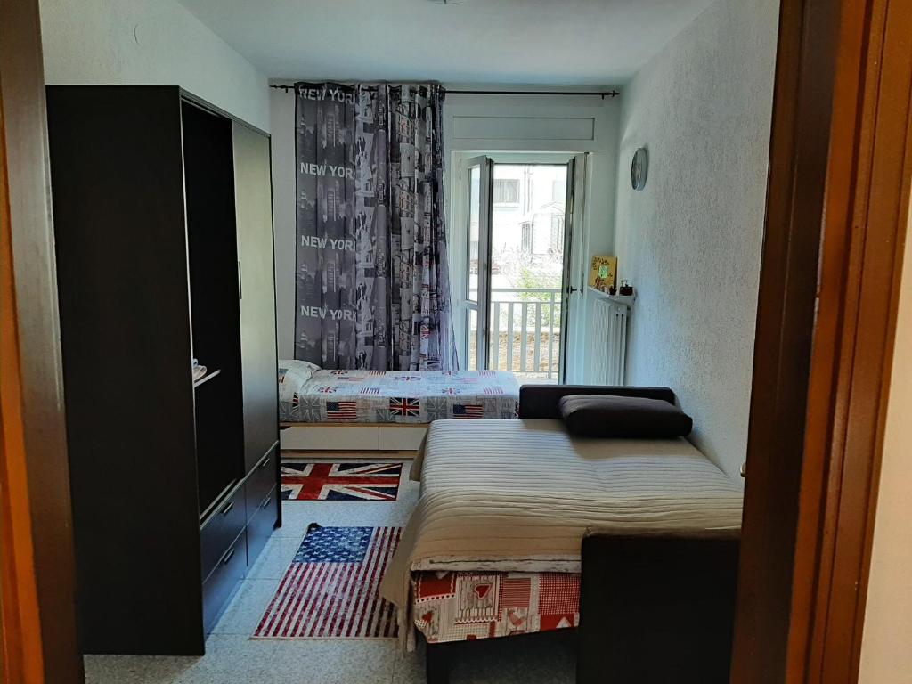 a small bedroom with a bed and a window at Case Gemelle - CIR 0271 in Aosta