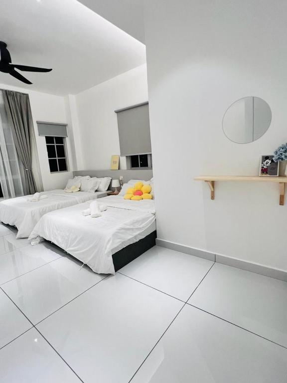- 2 lits dans une chambre aux murs blancs dans l'établissement Inn Homestay Cozy Room 1st Floor, à Teluk Intan