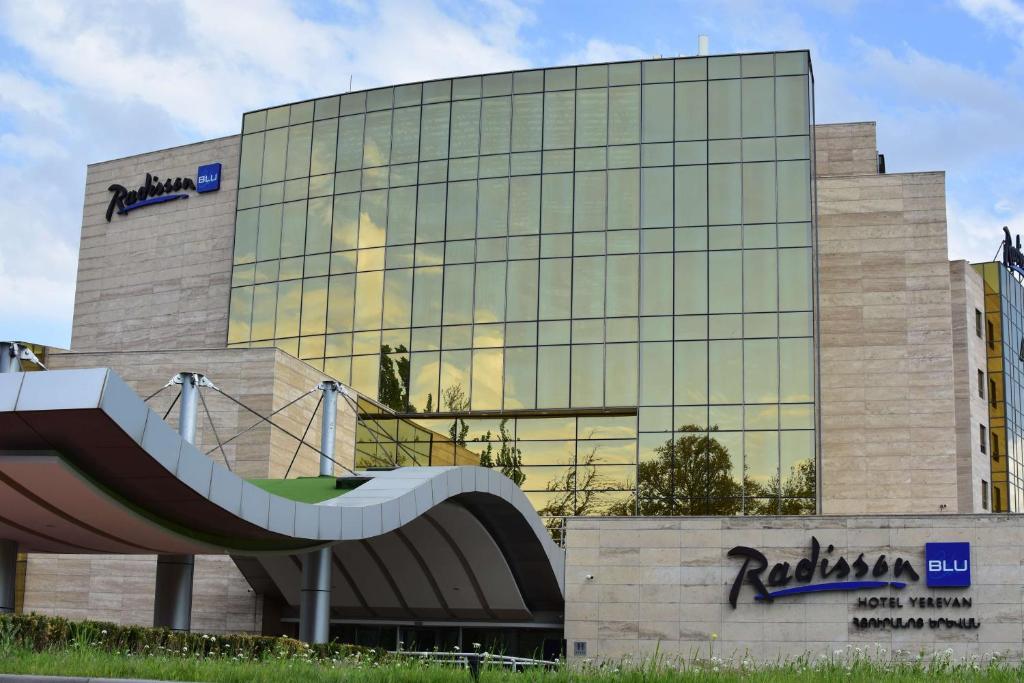a building with a slide in front of it at Radisson BLU Hotel Yerevan in Yerevan