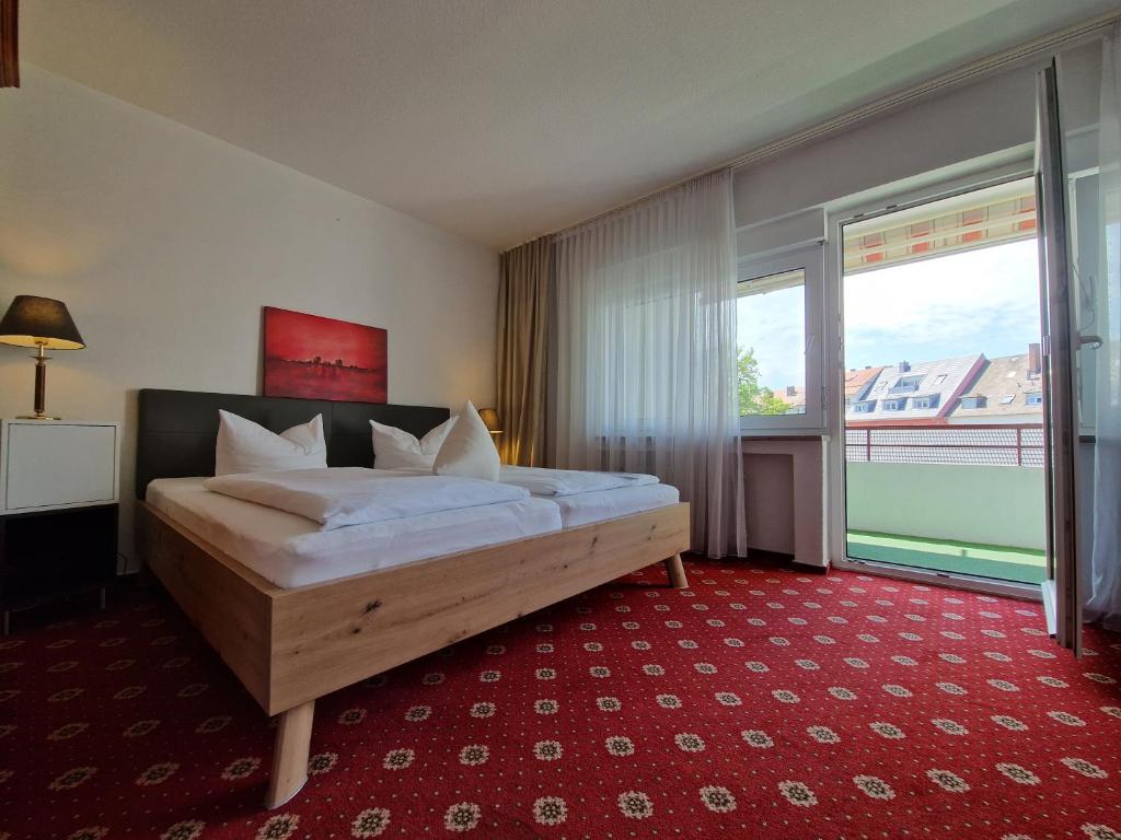 Postel nebo postele na pokoji v ubytování Apart Hotel Freiburg