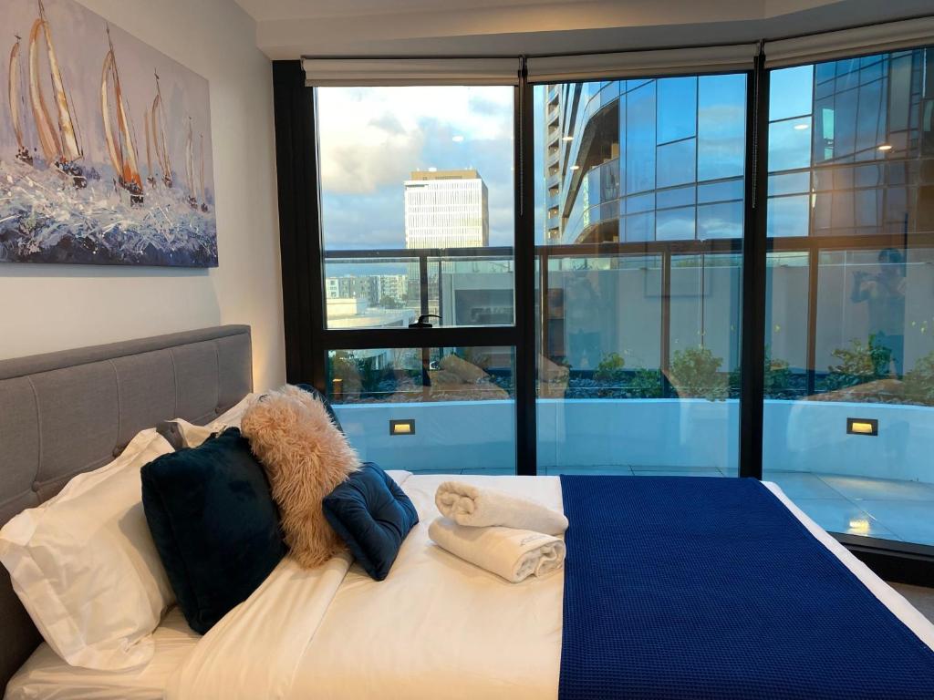 a bedroom with a large bed with a large window at Apartment with nice view in Boxhill 8A in Box Hill
