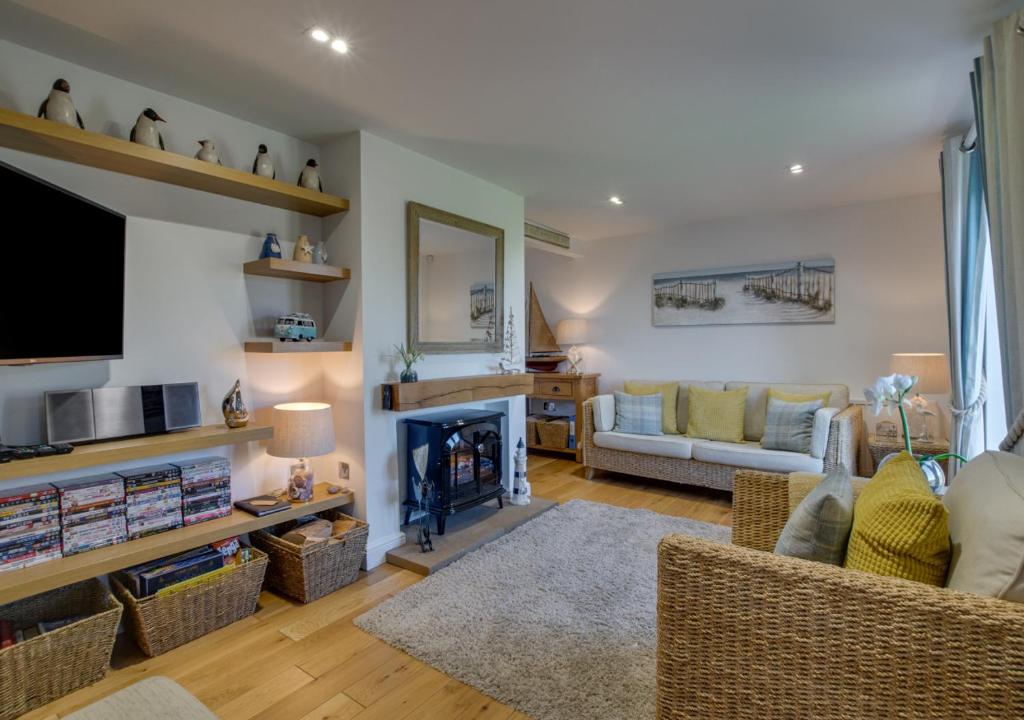 a living room with a couch and a fireplace at Finn Cottage in Bamburgh