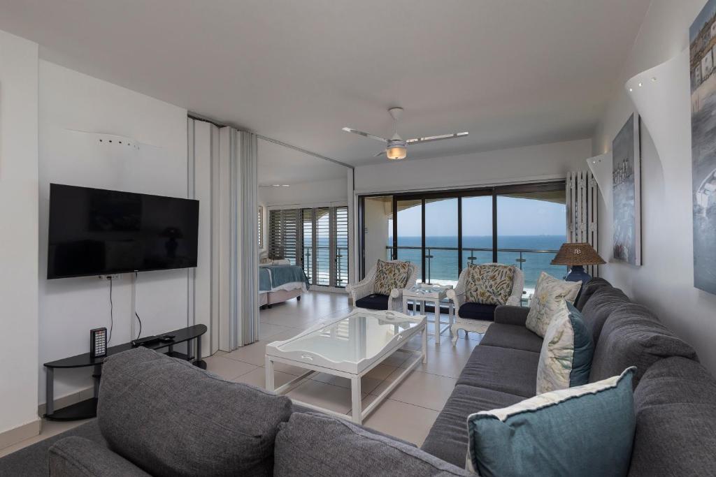 a living room with a couch and a table at 802 The Bermudas - by Stay in Umhlanga in Durban