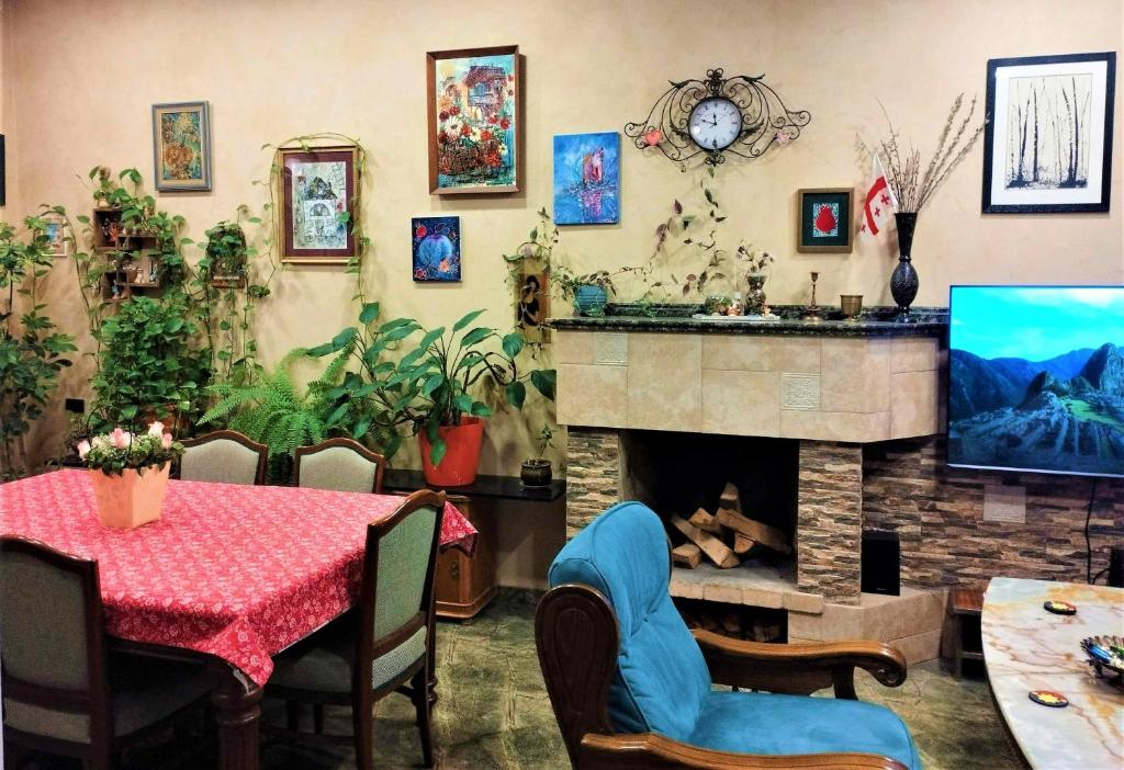 a living room with a fireplace and a table and a tv at N38 in Tbilisi City