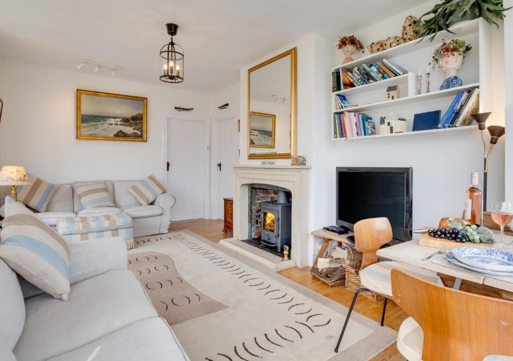 a living room with a couch and a fireplace at Sandy Dell in Beadnell