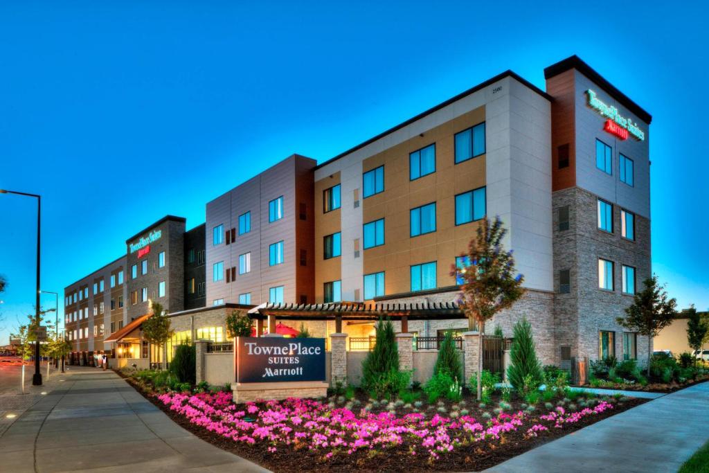 a hotel with flowers in front of a building at TownePlace Suites by Marriott Minneapolis near Mall of America in Bloomington