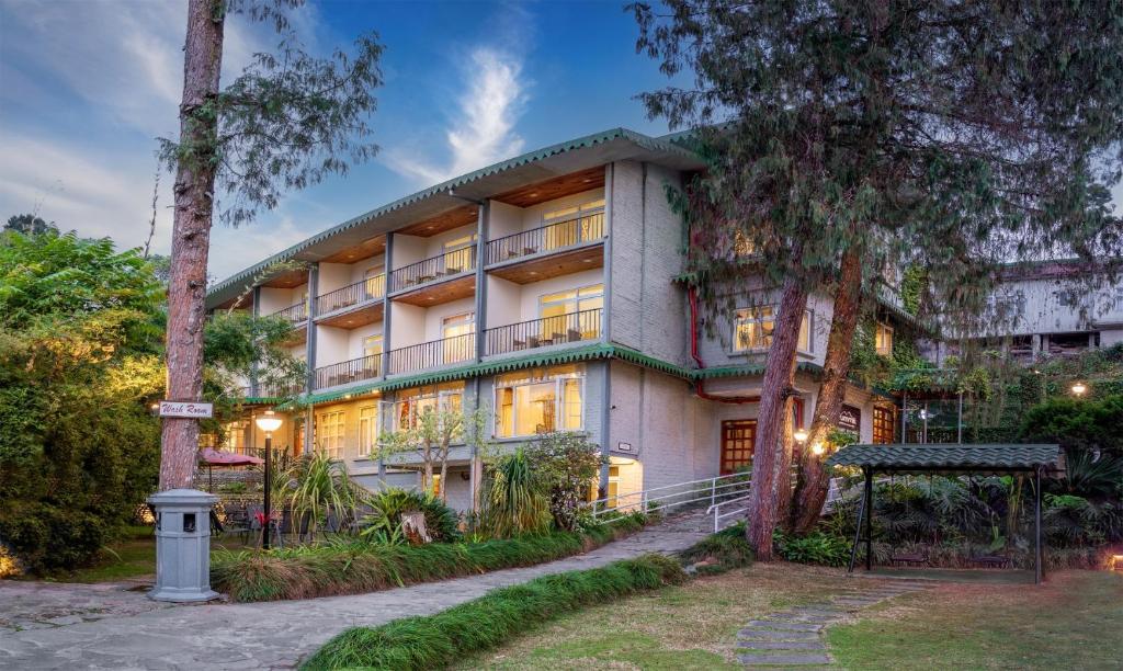 a large building with trees in front of it at Summit Barsana Resort & Spa in Kalimpong