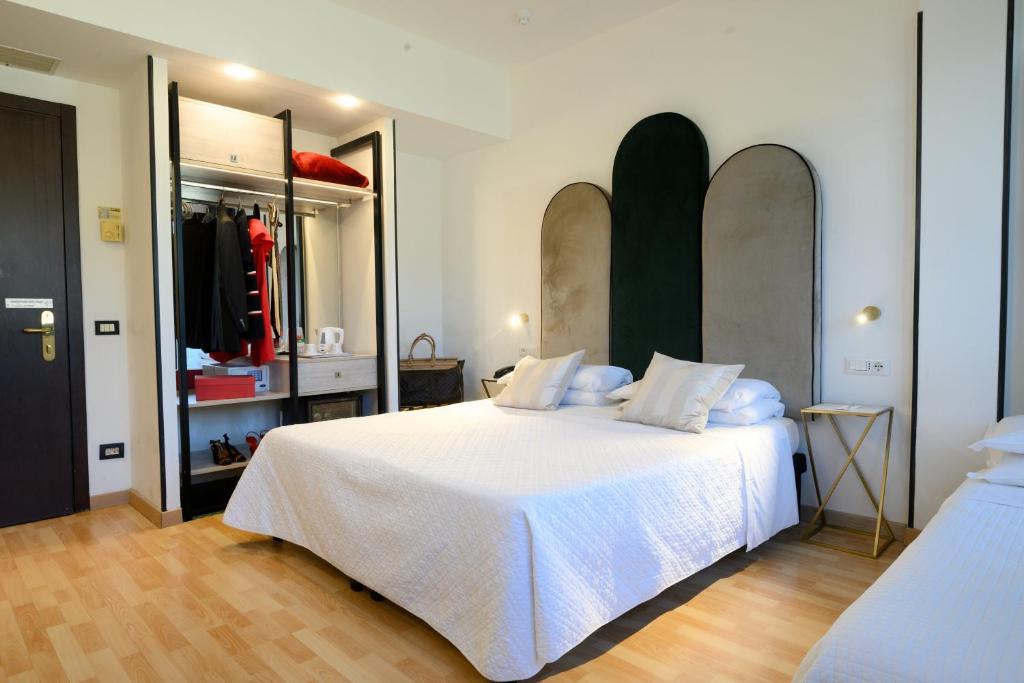 a bedroom with a large white bed in a room at Art Hotel Milano in Prato