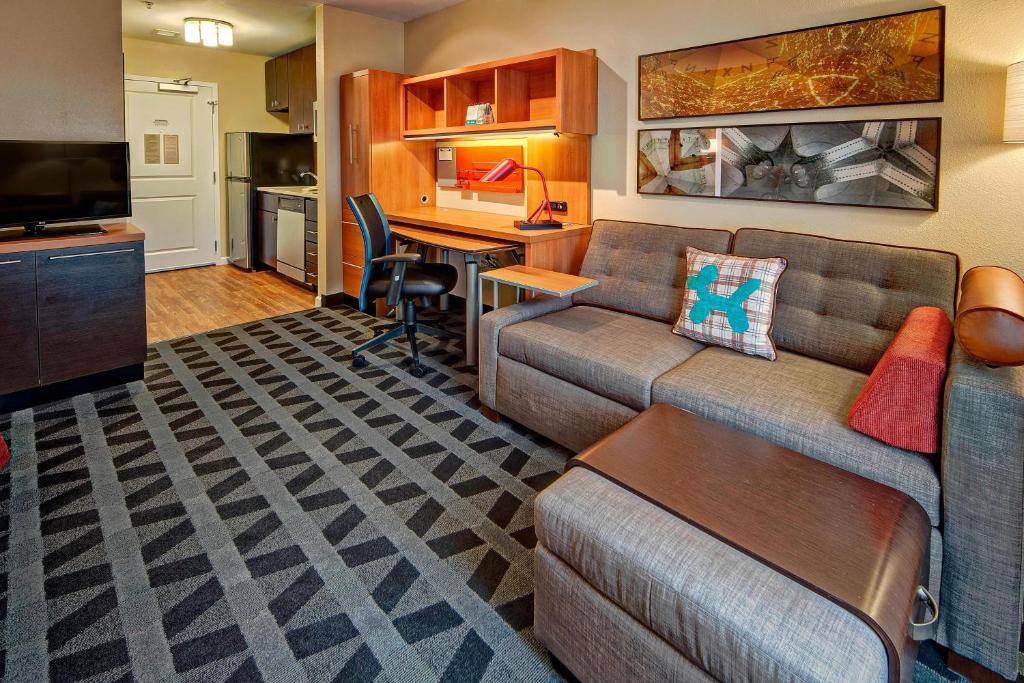 a living room with a couch and a table at TownePlace Suites by Marriott Hattiesburg in Hattiesburg