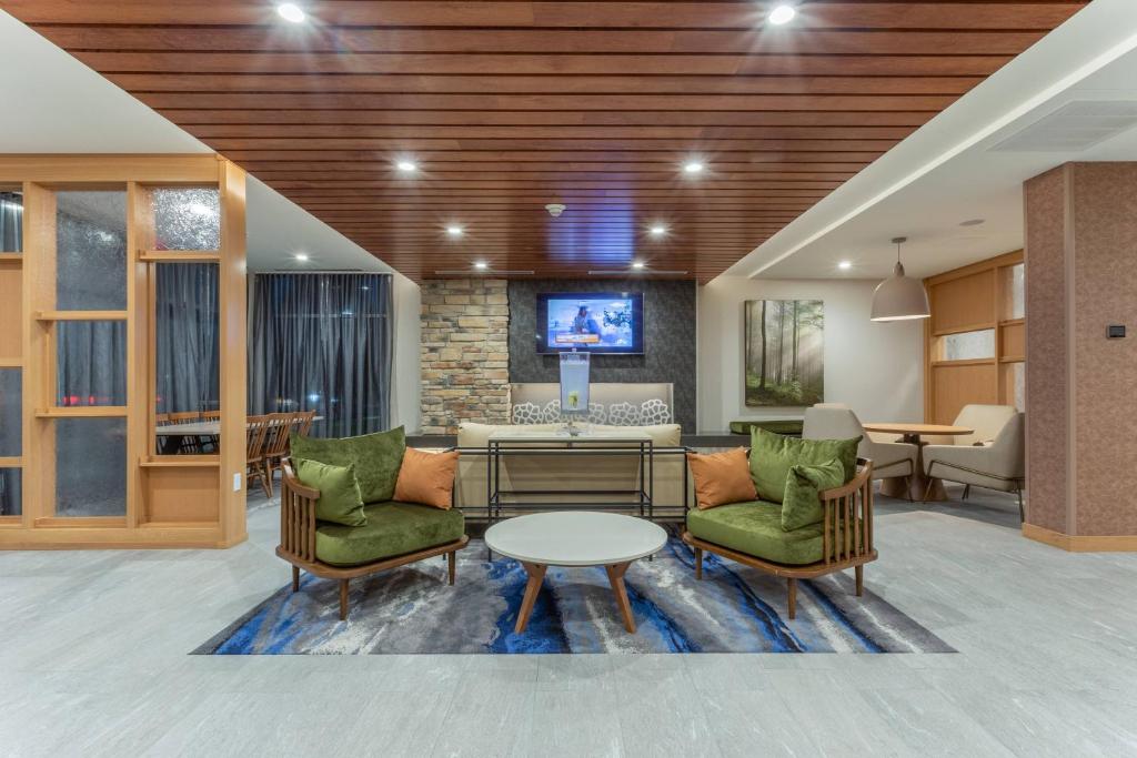 a living room with two chairs and a table at Fairfield Inn & Suites Franklin in Franklin