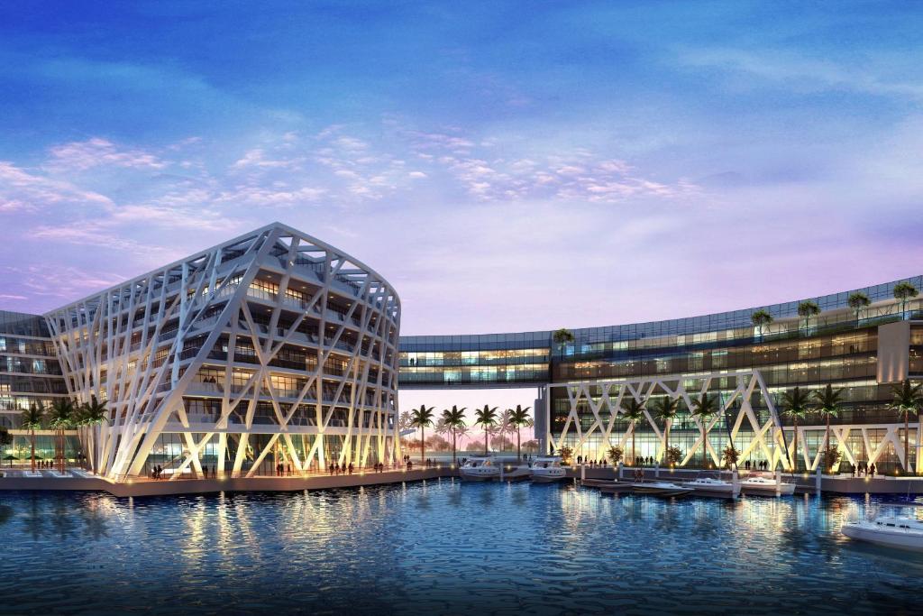 a rendering of a large building with water in front at The Abu Dhabi EDITION in Abu Dhabi