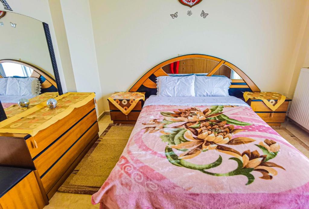 a bedroom with a large bed with a pink blanket at Villa Etheras - Nested between Nature by Amazing View - 5 mins from Edessa in Edessa