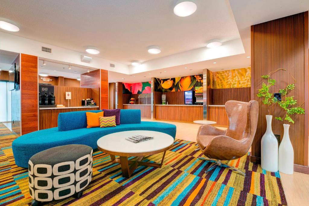 a living room with a blue couch and a table at Fairfield Inn & Suites by Marriott Greenville Simpsonville in Simpsonville