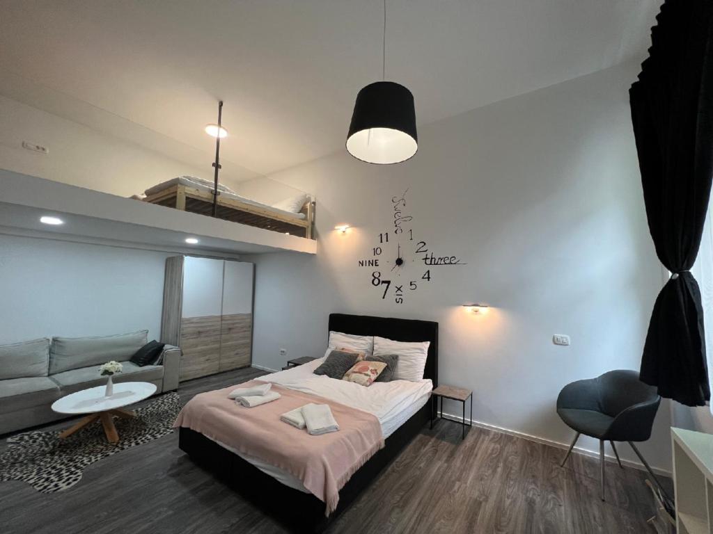 a bedroom with a large bed and a couch at Absolutum Apartments in Ljubljana