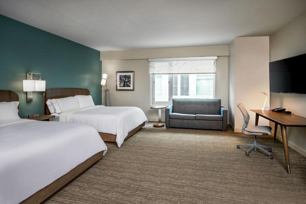 A bed or beds in a room at Element Hampton Peninsula Town Center