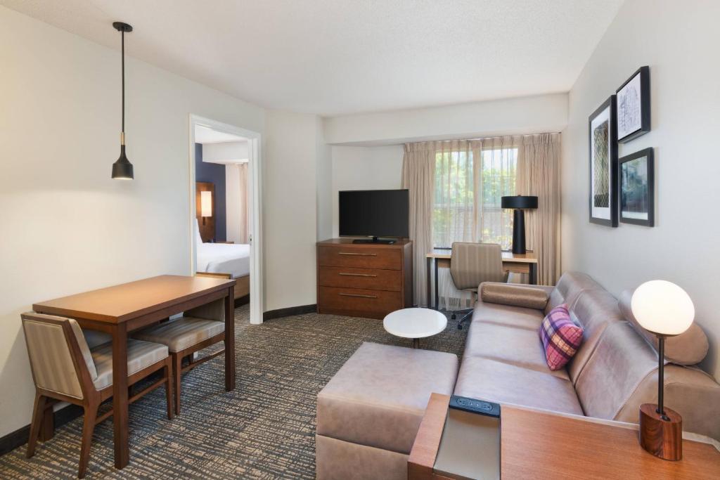 a living room with a couch and a table at Residence Inn by Marriott State College in State College