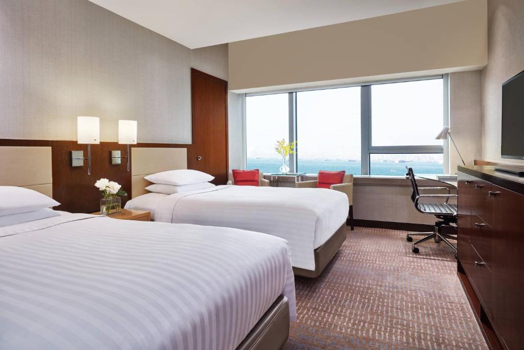 A bed or beds in a room at Courtyard by Marriott Hong Kong